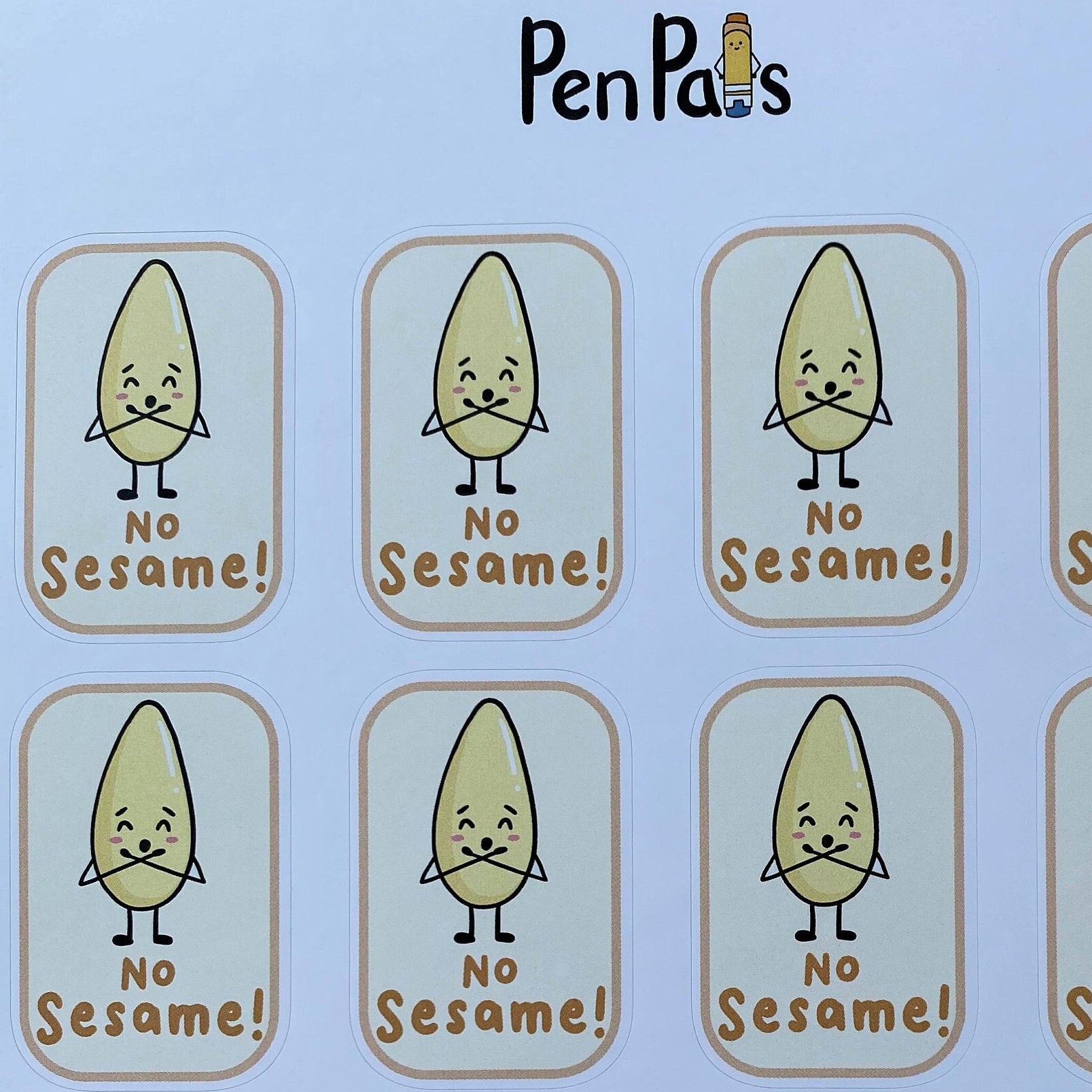 A sheet of ten planner stickers featuring a cartoon sesame seed character with the text 'NO Sesame!' printed on a white background, placed on a wooden surface. The brand name 'PenPals' is printed at the top.