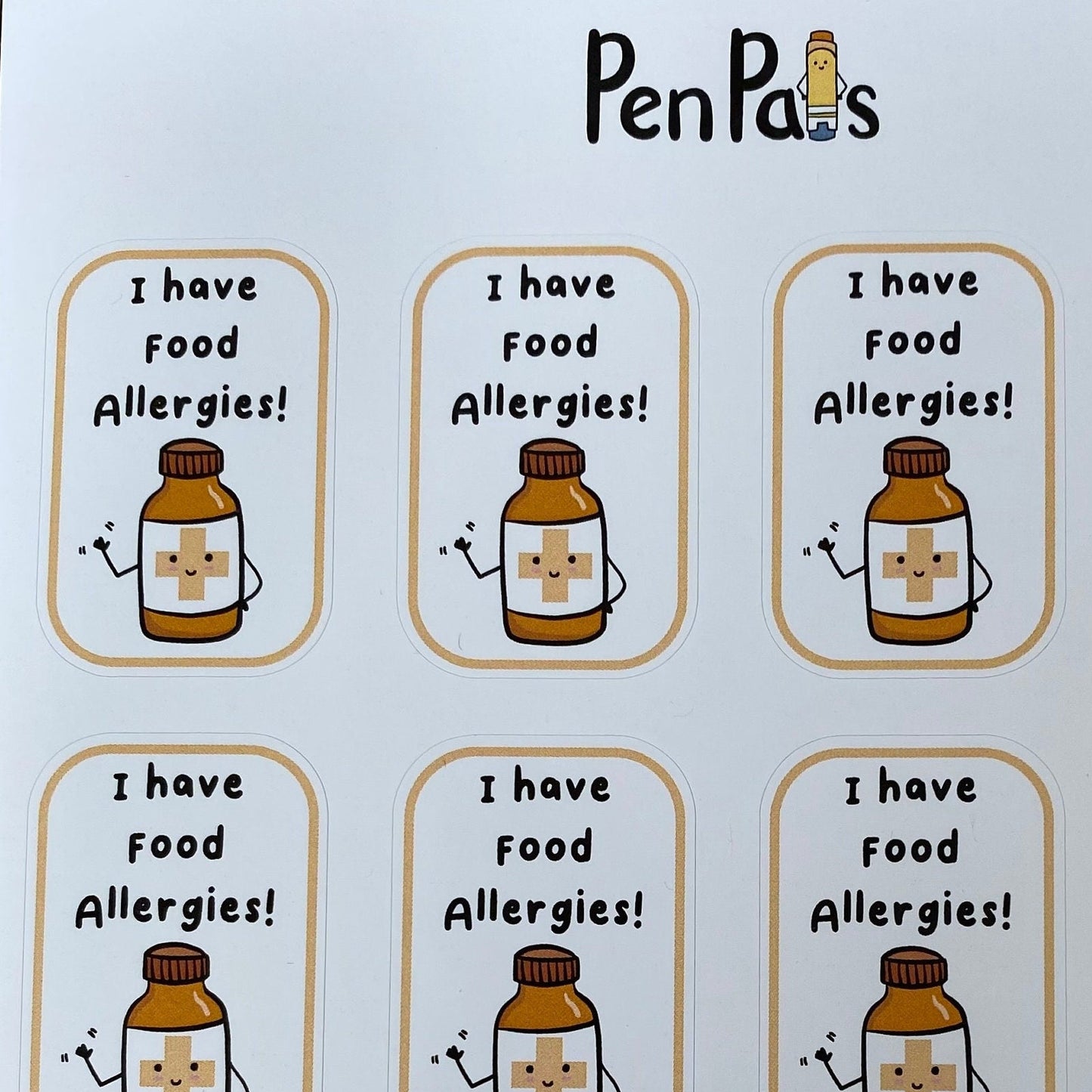 A sheet of nine 'PenPals' food allergy stickers, each featuring a cute cartoon first-aid bottle with a cross and the text 'I have food Allergies!'.